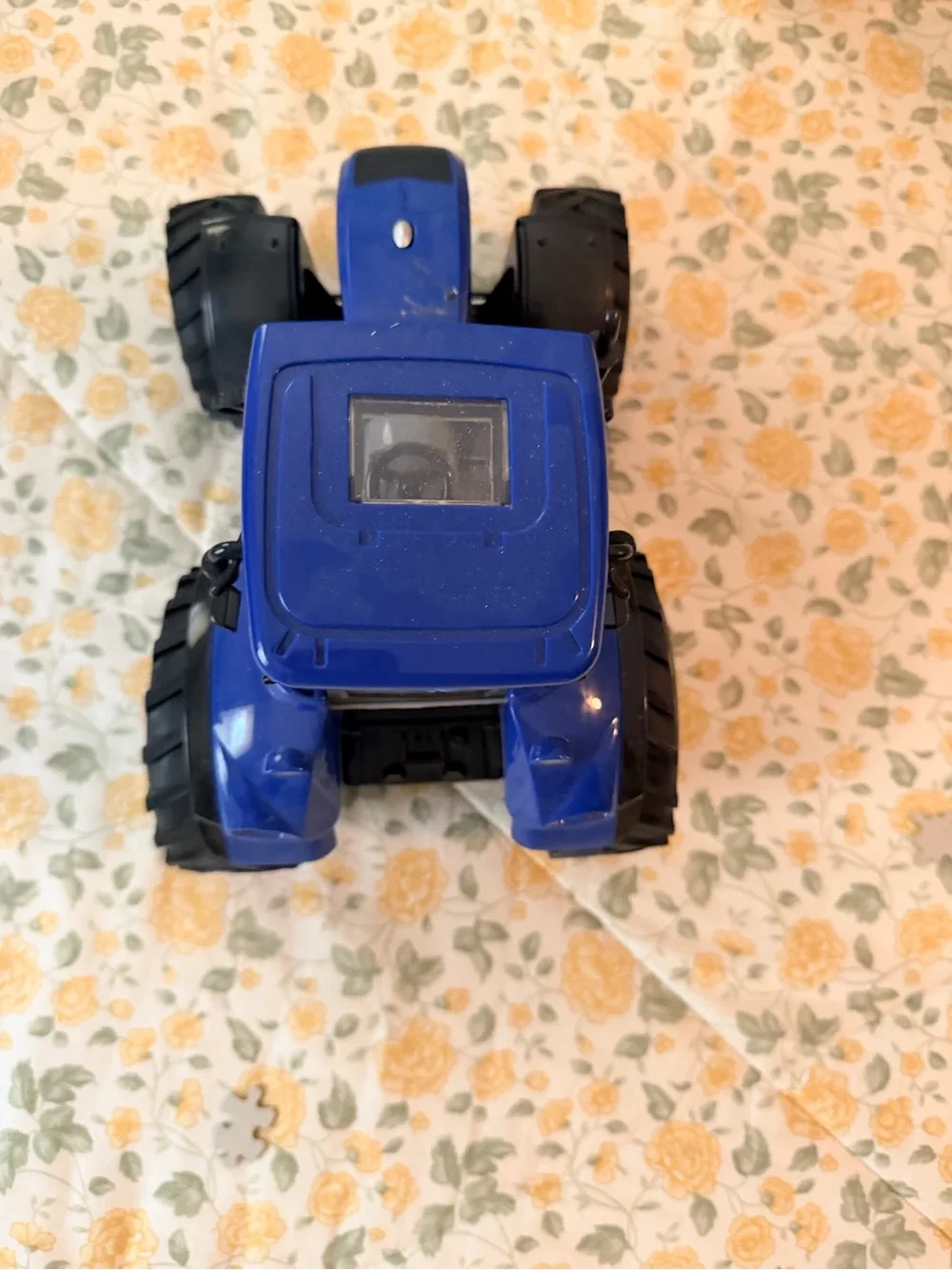 Medium plastic blue and black electronic toy tractor, lights up with sound